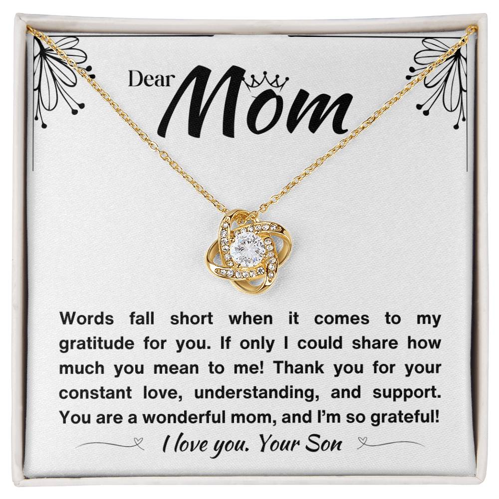 Elegant yellow gold necklace with a knot pendant and a message of gratitude to a mom.