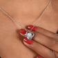 A close look at the Love Knot necklace on a woman's neck .