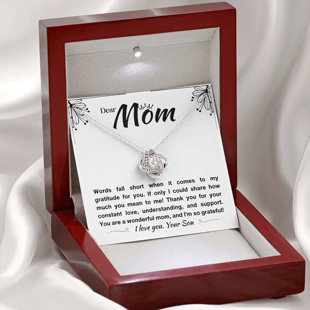 Beautiful gift for Mom: a silver love knot necklace with a heartfelt message in white background

