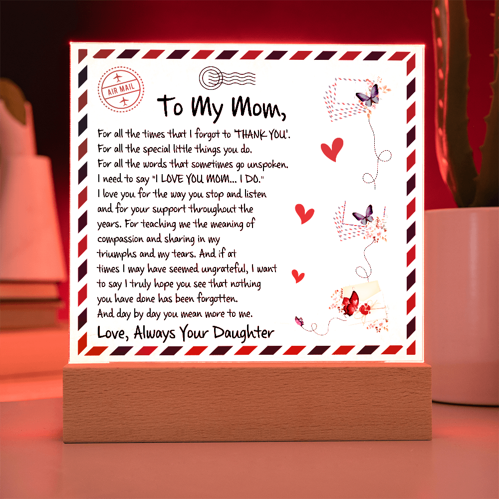 A sentimental letter to Mom on a vintage airmail plaque with butterflies, hearts, and a warm wooden LED stand.